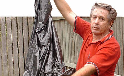 Geoff Williams with the large garbage bag and attached burnt-out fuel source he found in his backyard in Newtown. Geoff Williams with the large garbage bag and attached burnt-out fuel source he found in his backyard in Newtown.